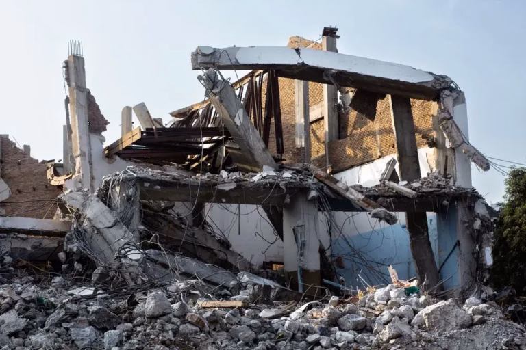 Partly demolished house with rubble during a home and structural demolition
