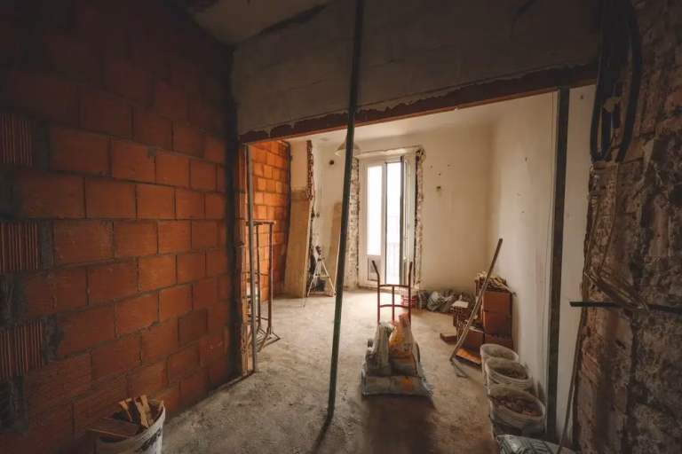 Gutted room with walls stripped during interior demolition and selective removal